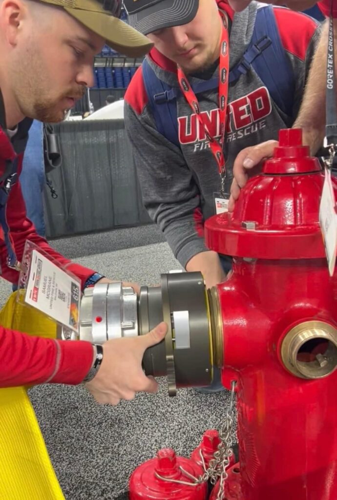 Side view of Hy-Conn connector with attached hose