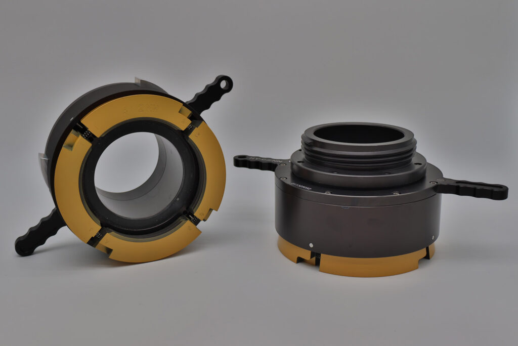 Pair of Hy-Conn fittings displayed on workbench